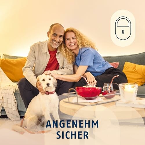 Paar sitzt mit Hund auf Sofa, Kerzen und Getränke auf dem Tisch